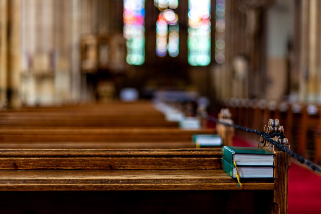 bible on a pew in a church United Church